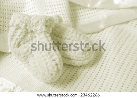 Baby booties on a soft baby blanket.  Soft and warm for the new arrival.