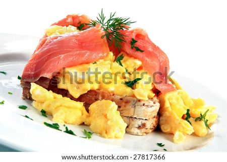 Scrambled eggs with smoked salmon, garnished with dill and parsley.  A delicious breakfast treat!