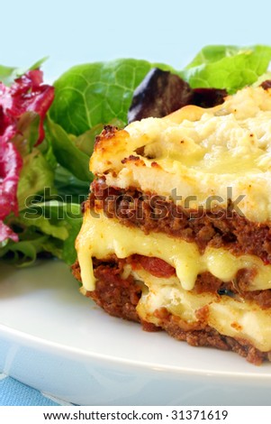Beef lasagne with melting mozzarella and ricotta cheeses, with a salad.
