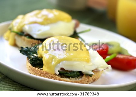 Eggs Benedict.  Toasted muffins with spinach, poached eggs, and delicious buttery hollandaise sauce.
