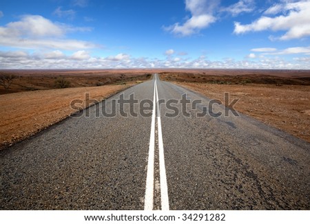 Open road in Australian outback.  Mundi Mundi, west of Silverton, New South Wales.  The horizon is so vast that you can see the curvature of the Earth.