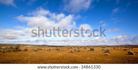 Panorama of the red desert of the Australian outback, with brilliant blue sky.  Western New South Wales.