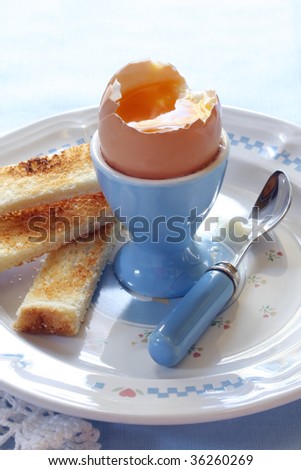 Soft-boiled egg in an egg cup, with toast \