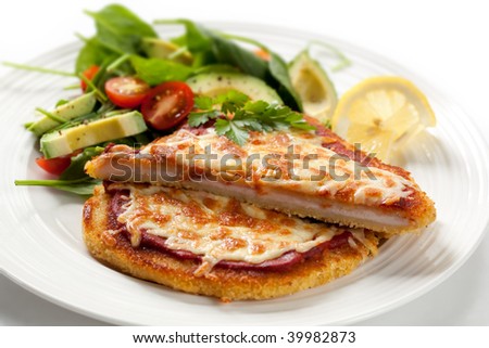 Delicious chicken schnitzel topped with passata and melting cheese, with a spinach and avocado salad.