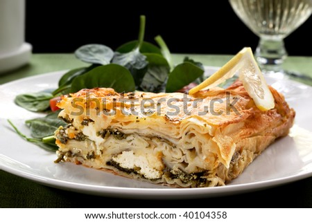 Spinach pie and salad, with a glass of wine.