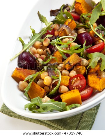 Salad with chickpeas, roasted vegetables, baby beets, cherry tomatoes, and arugula.  Delicious vegetarian eating.