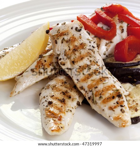 Grilled chicken tenderloin breast strips, with a salad of red capsicum and eggplant.