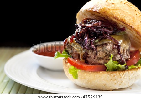 Healthy hamburger.  Lean meat with salad, tomatoes, low-fat cheese and caramelized onions.