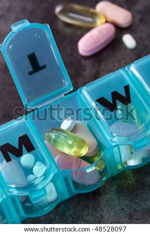 Daily pill box with medications and nutritional supplements.
