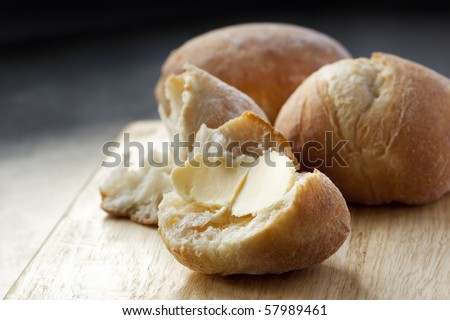 Buttered bread roll.  Lovely and crusty, ready to eat.