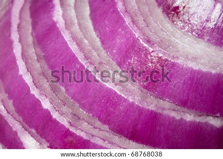 Slices of red onion, in close-up.