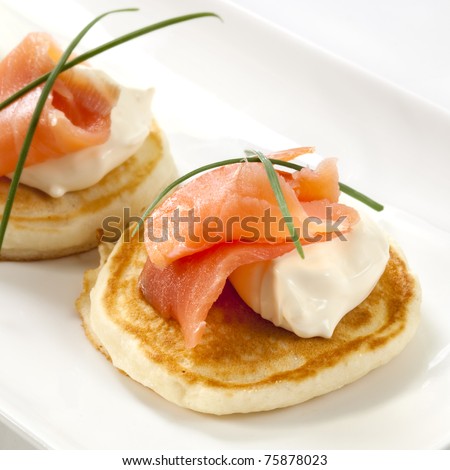 Blini topped with smoked salmon and sour cream.