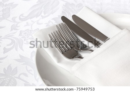 White linen napkin, with silver cutlery.