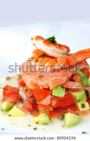King prawns with smoked salmon, over an avocado salsa.