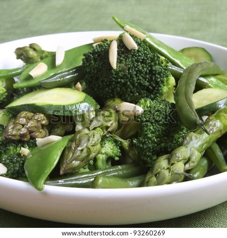 Sauteed green vegetables, topped with almonds.  Delicious, nutritious eating.