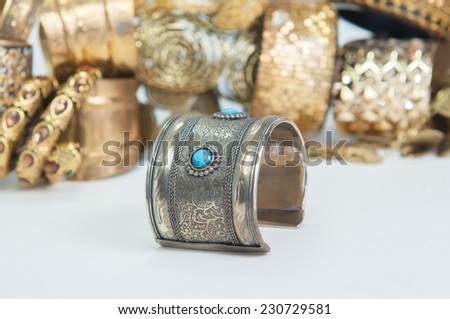 Beautiful expensive gold bracelets and ring on white background