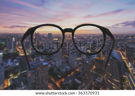 Glasses with clear vision of night cityscape focused