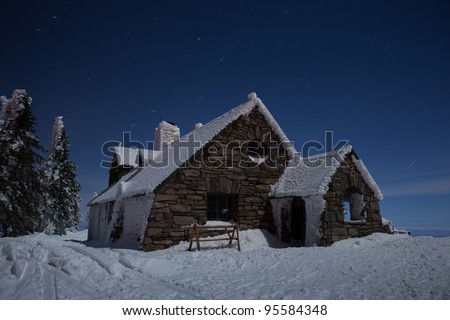 Star Trails Streaking over Ski Lodge on the top of a Mountain at Night