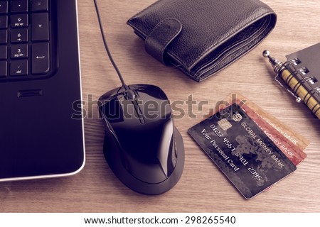 Electronic payments from desktop. Composition on the subject of using modern means of payment for online shopping. Photo and graphic compositing.