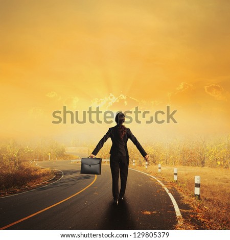 Relax business woman holding bag on Country road and sunset