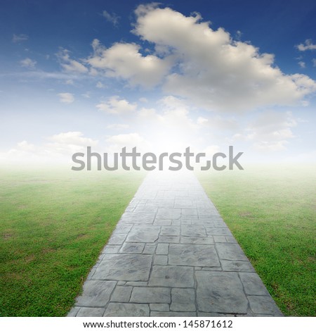 Concrete road in Grass fields and Sun sky