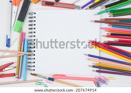 Notebook and school or office tools on white background