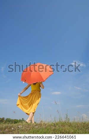 Red umbrella woman standing and cloud sky
