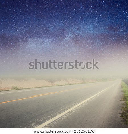 Asphalt road in forrest and star night