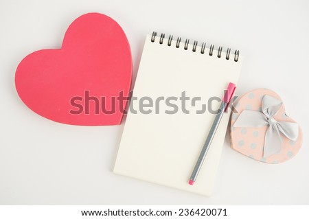 Heart gift box and note book pen on  white background