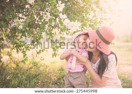 Happy family Vintage tone. A son kiss his mother on outdoors