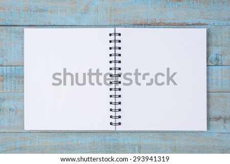 Notebook on blue wood table  for text and background