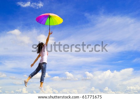 Multicolor umbrella woman jump to sky
