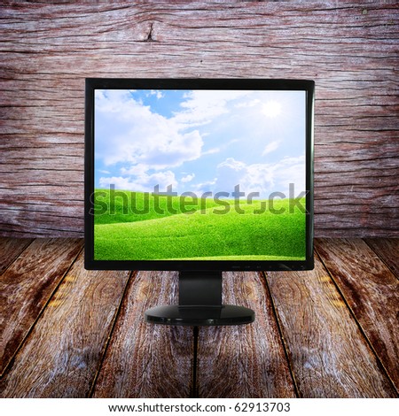 LCD monitor on wood floor and wall