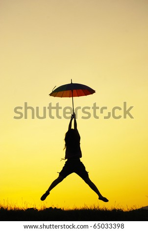 Umbrella woman jump and sunset silhouette