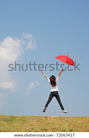 Red umbrella woman jump to sky