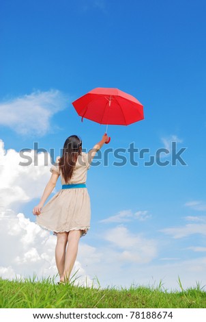 Woman holding red umbrella and cloud sky