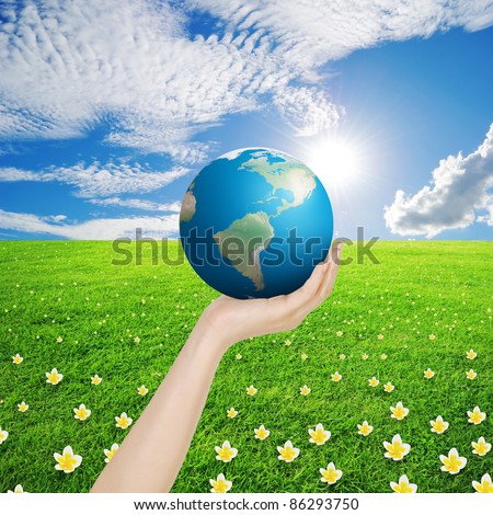 Hand and world in Grass fields and sun sky , photo of Earth from NASA