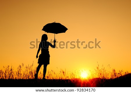 Umbrella woman jump and sunset silhouett