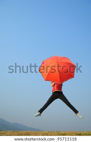 Red umbrella woman jump to Blue sky
