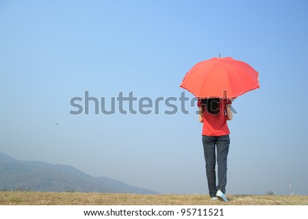 Red umbrella woman wait for someone and cloud sky