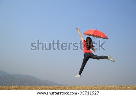 Red umbrella woman jump to Blue sky
