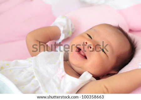 infant sleep on the bed and smiling