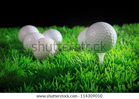 golf ball on white tee with green grass field