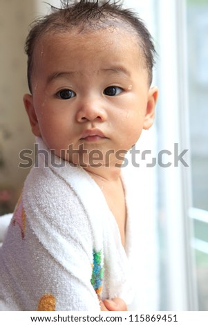 face of asian baby after take a bath with wet body