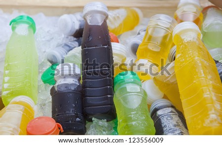 cold drinking fruit juice beverage in ice cooler