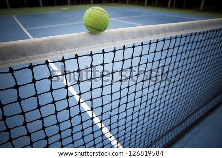 tennis ball over black net semm win or loose never Know