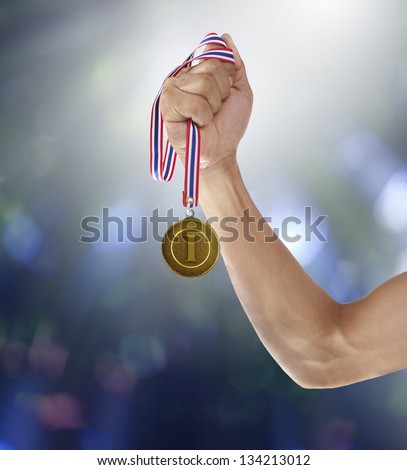 hand and gold medal