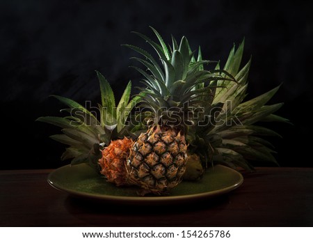pineapple in ceramic dish with low key light in studio