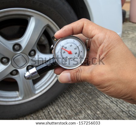 checking tire air pressure with meter  gauge before traveling for multipurpose