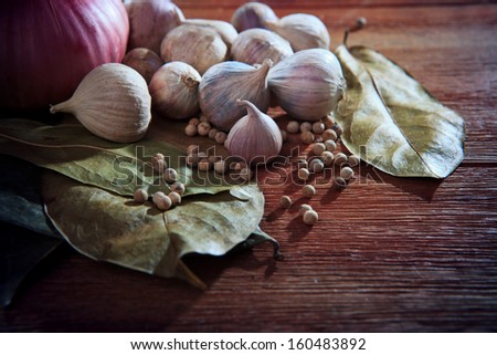 eastern food style dry spice herb garlic red onion white pepper dry leaves  on wood table